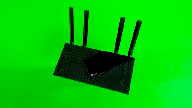 TP-Link Archer AX21 wi-fi router on a green background.