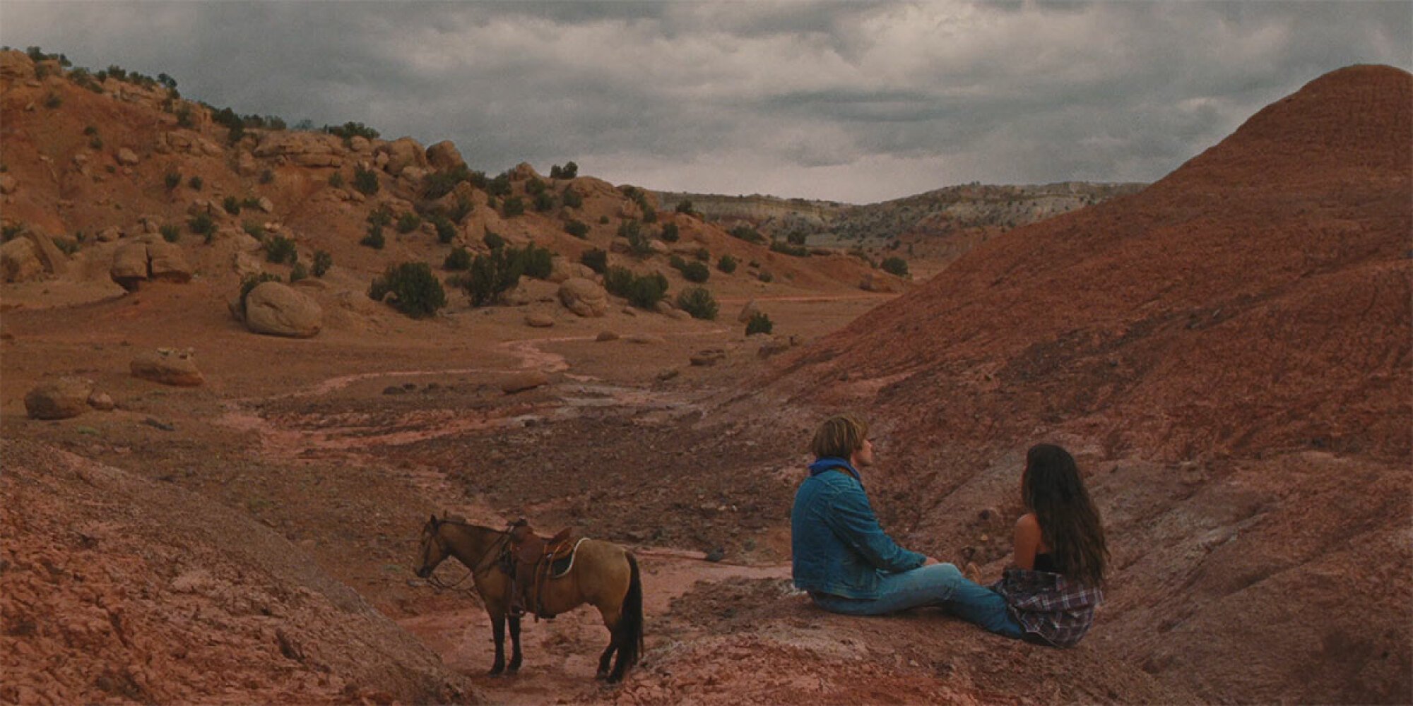 Charlie Plummer and Eve Lindley sit on the range in "National Anthem."